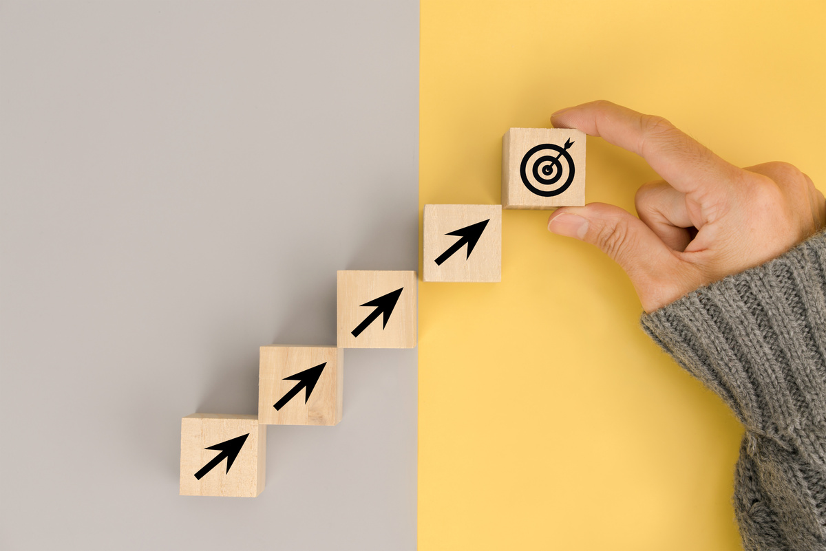 Businessman hand arranging wood block with icon business strategy